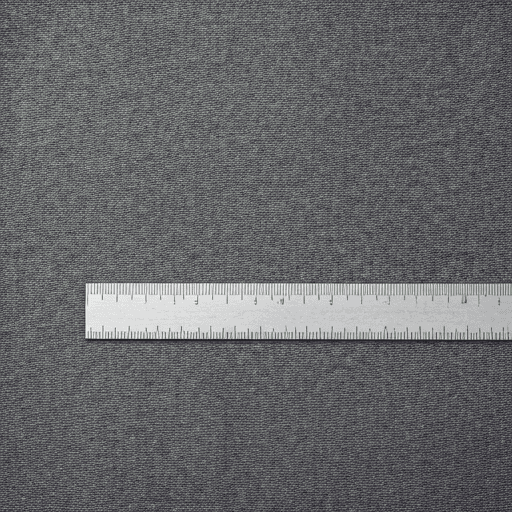 Grey jersey fabric measured with an industrial ruler for apparel sourcing