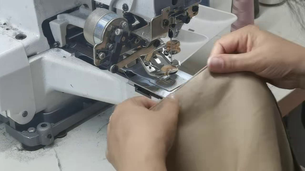 Trim and label attachment machine working on a garment at Meiting Garments