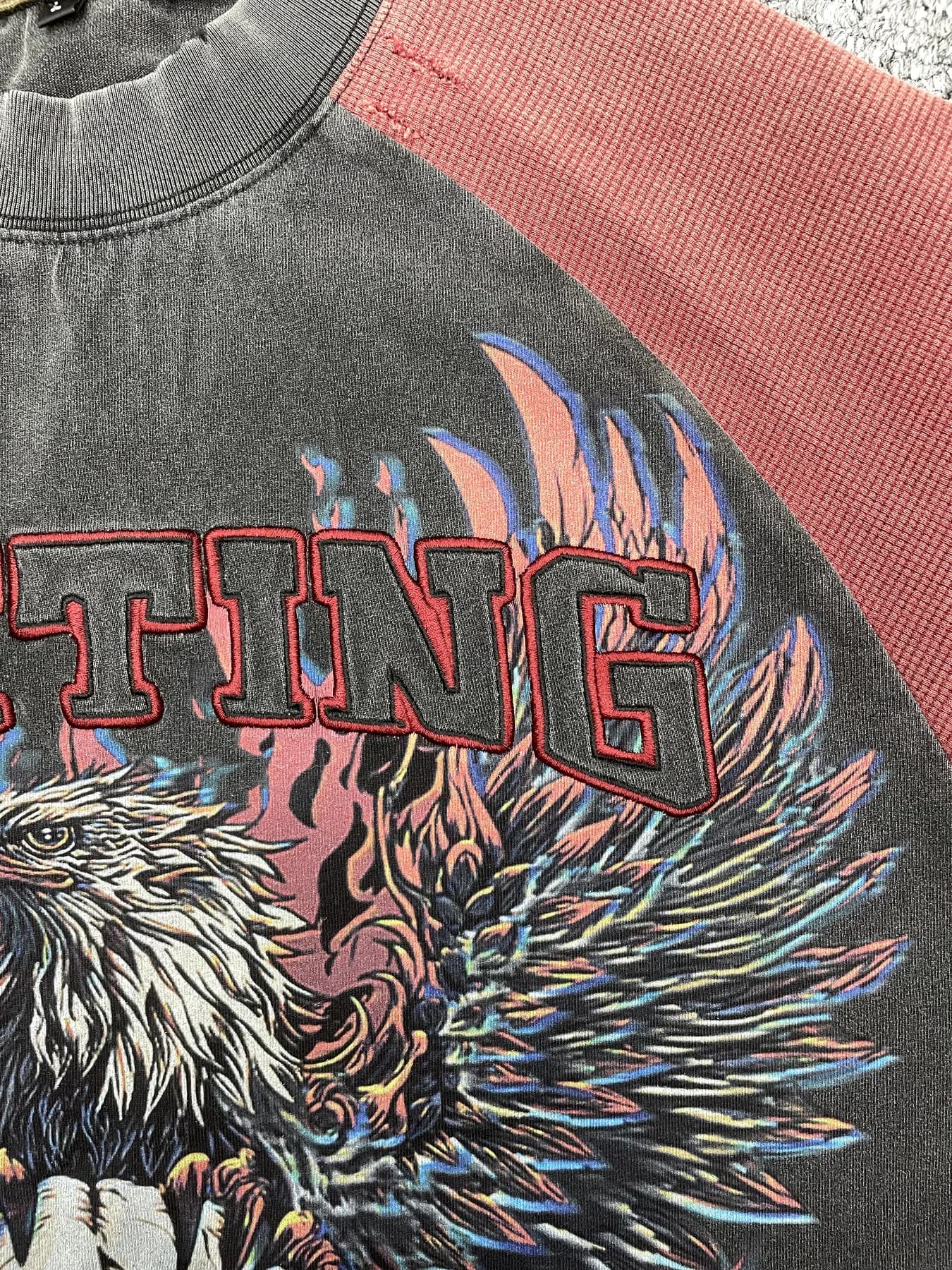 Close-up of multicolor garment printing combined with raised embroidered lettering