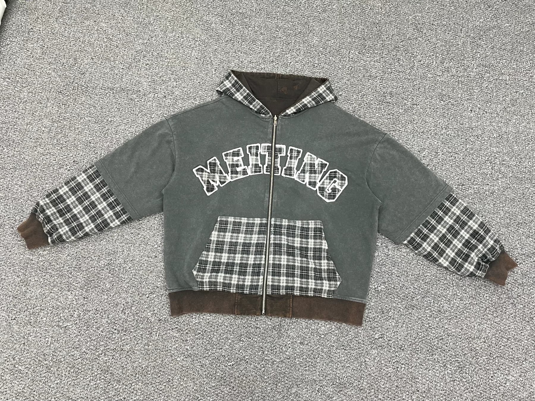 Washed grey zip hoodie with plaid panels laid flat